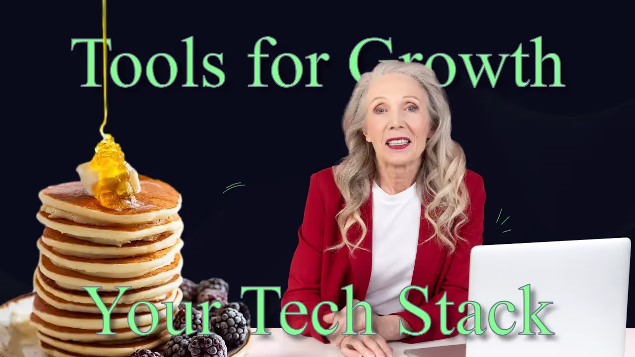 Grey haired lady in red business blazer sitting in front of a laptop giving a talk with a large stack of pancakes on the table
